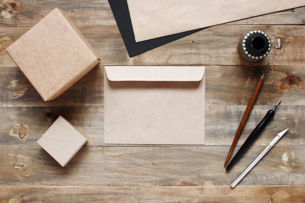 istock Empty envelope and vintage stationery on the old wooden table 844365252