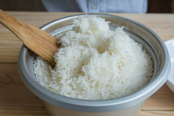 istock Cook rice in a pot on a wooden table 844365404