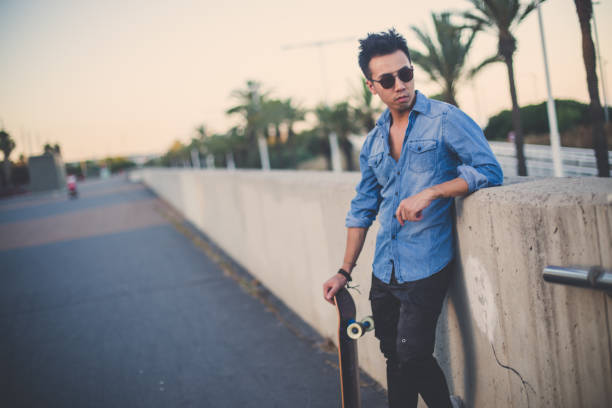istock Hipster man with skateboard outdoors 844371664