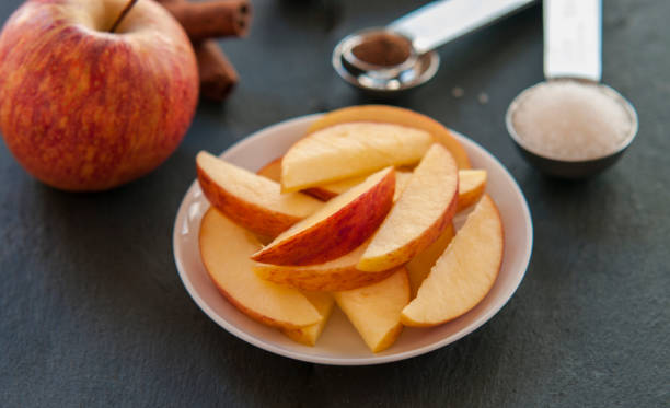 istock plate of apple slices on dark background 844372072
