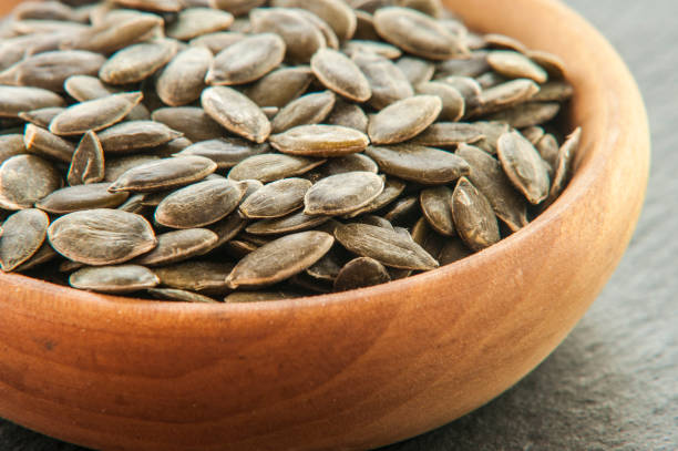 istock Full bowl of pumpkin seeds close up 844372120