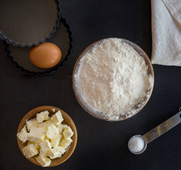 istock flour and ingredients on black table. Top view 844372134