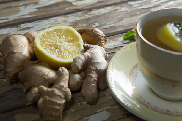 istock Close up of lemon amidst gingers by tea on table 844379154