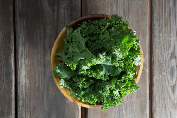 istock Overhead view of kale in bowl on table 844379412