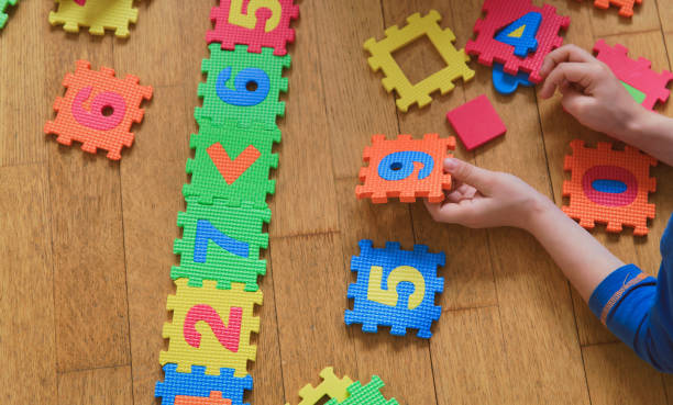 istock child playing with puzzle, education concept 844382514
