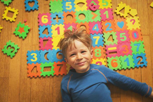 istock happy little boy playing with puzzle, education 844382598
