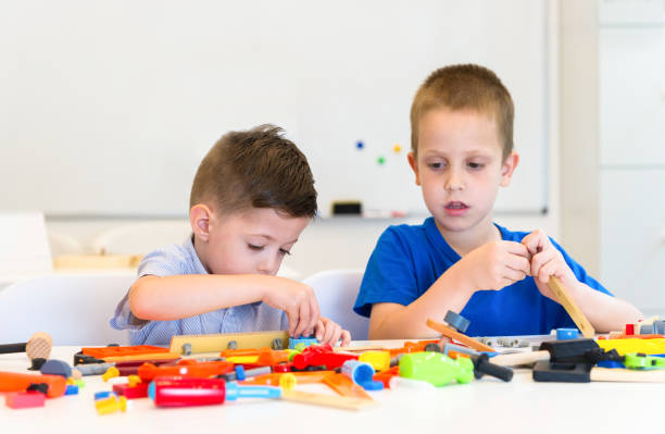 istock two child boy play repair toys 844382994