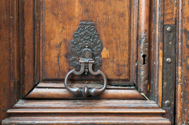 istock Royal style doorknocker on old wooden door. 844383014