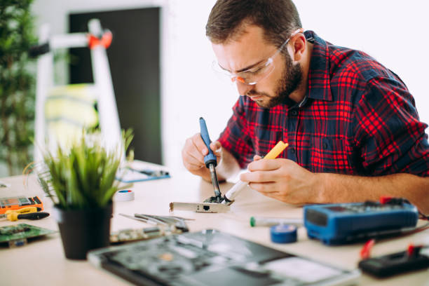 istock Repairman using solderwick for desolder in board electronic 844383076