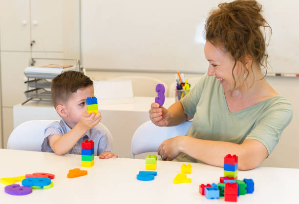 istock teacher woman learn  preschooler boy to count 844386064