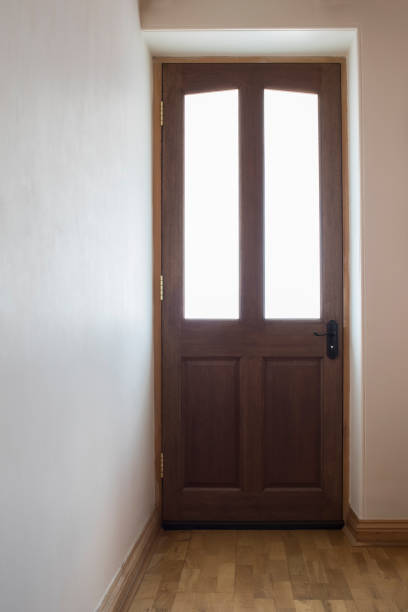 istock Wooden Front Door To House With Light Through Windows 844389000