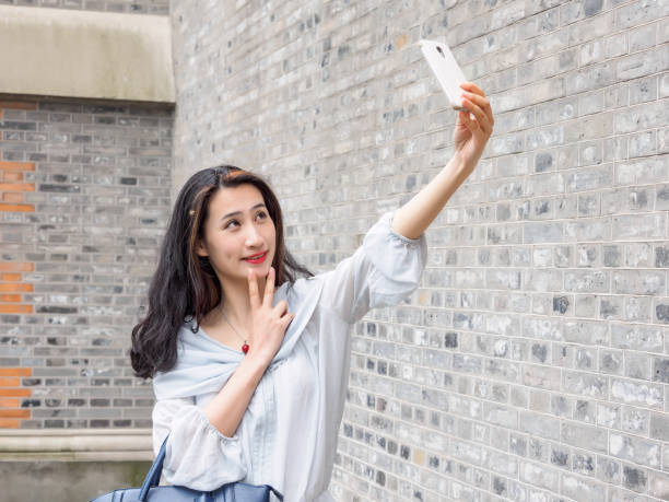 istock Beautiful Asian woman taking selfie using smart mboile phone. 844389228