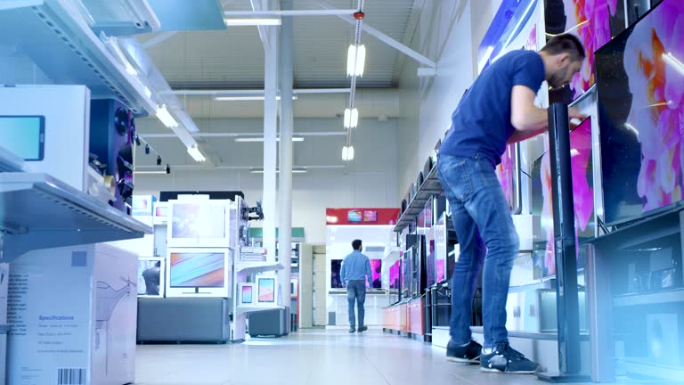 Time-Lapse Footage of Busy Day in a Big, Modern Electronics Store Where Many People are Browsing, Buying Newest Available TV's, Cameras, Tablets and Other Devices.