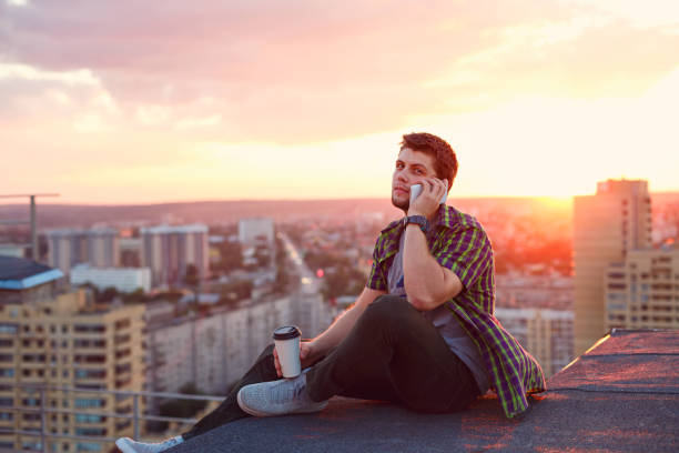 istock Man drinking coffee and talking on phone 844390180