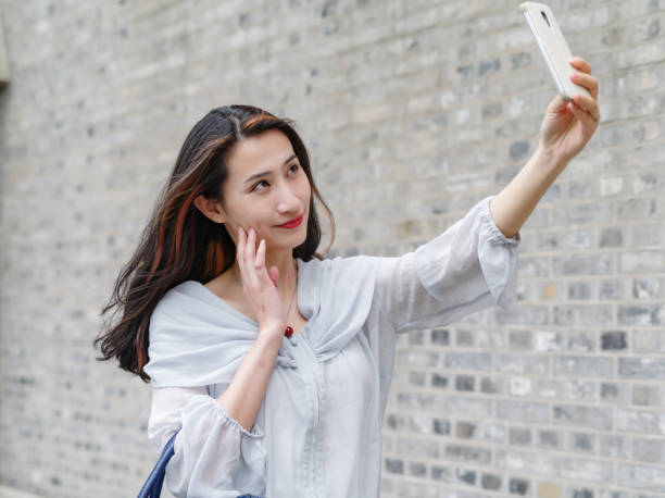 istock Beautiful Asian woman taking selfie using smart mboile phone. 844390216
