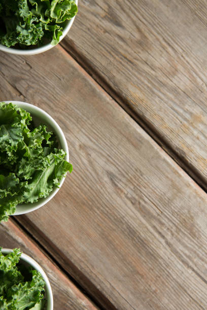 istock Overhead view of kale in bowls on brown table 844393000