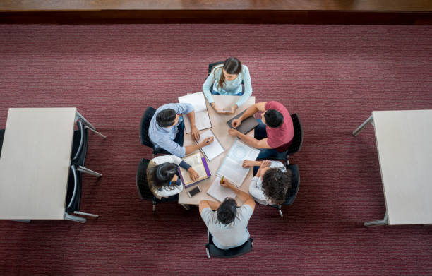 istock Group of students studying together in the library 844393104