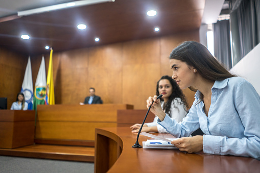 Lawyers presenting their case in trial and addressing the court - legal system concepts