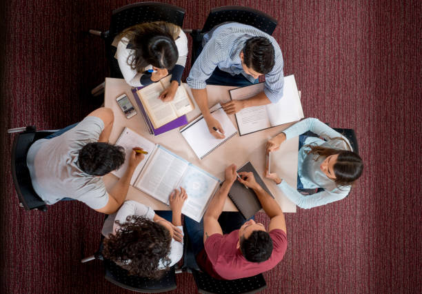istock Group of college students studying together in a roundtable 844393200
