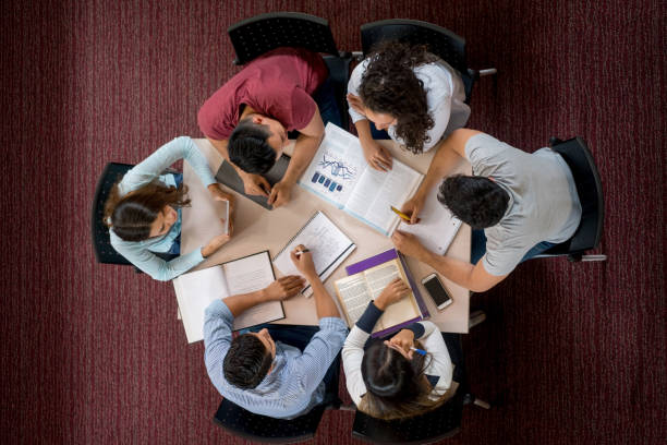 istock Group of college students studying together in the library 844393202