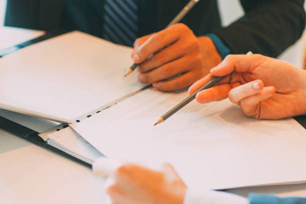 istock Cropped View of Colleagues Working With Documents 844393562