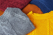 Concept knitted wool colorful warm sweaters closeup