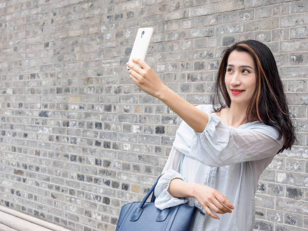 istock Beautiful Asian woman taking selfie using smart mboile phone. 844394018
