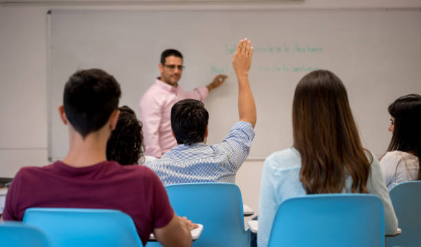 istock Student in class raising his hand to ask questions 844394402