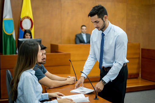 Portrait of a lawyer showing evidence in trial at a Colombian courtroom - legal system concepts