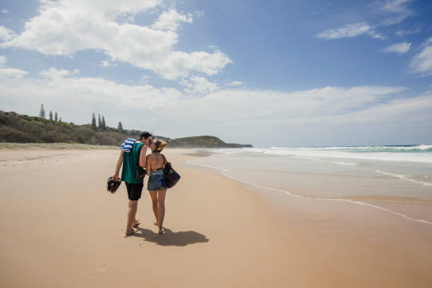 istock Young Couple Walking on the Beach 844397232