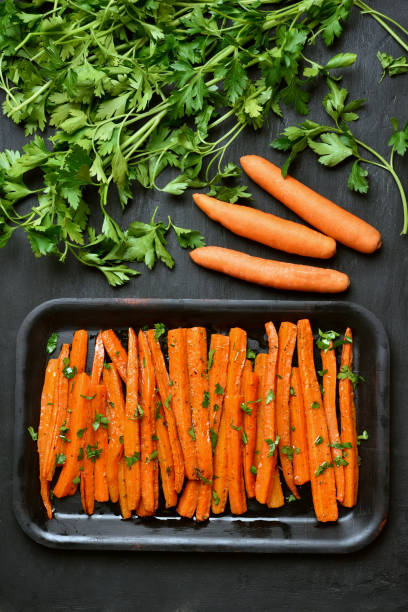 istock Roasted carrots with green herbs 844397238