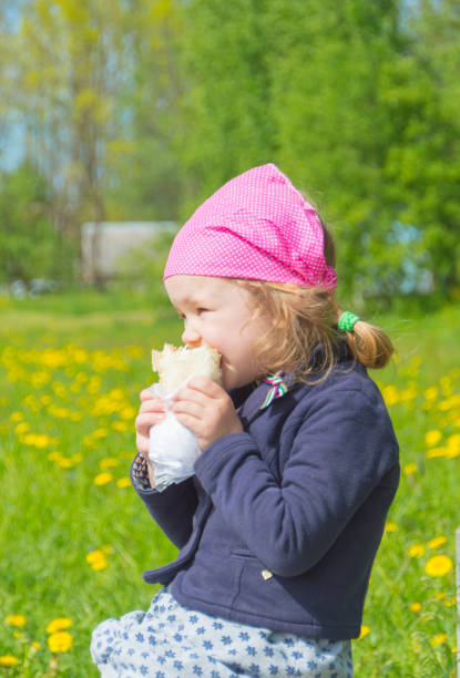 istock walking in the Park, the child eats fast food 844397988