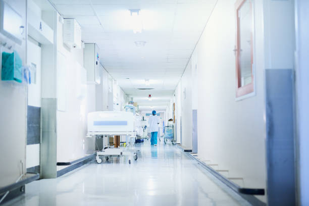 This way to wellness Rearview shot of a surgeon walking down a hospital corridor armed forces rank photos stock pictures, royalty-free photos & images