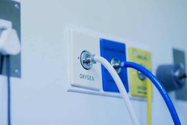 Life depends on it Shot of tubes connected to an oxygen supply mounted against a hospital wall medical oxygen equipment stock pictures, royalty-free photos & images