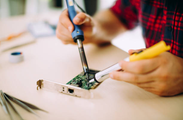 istock Repairman using solderwick for desolder in board electronic 844401454