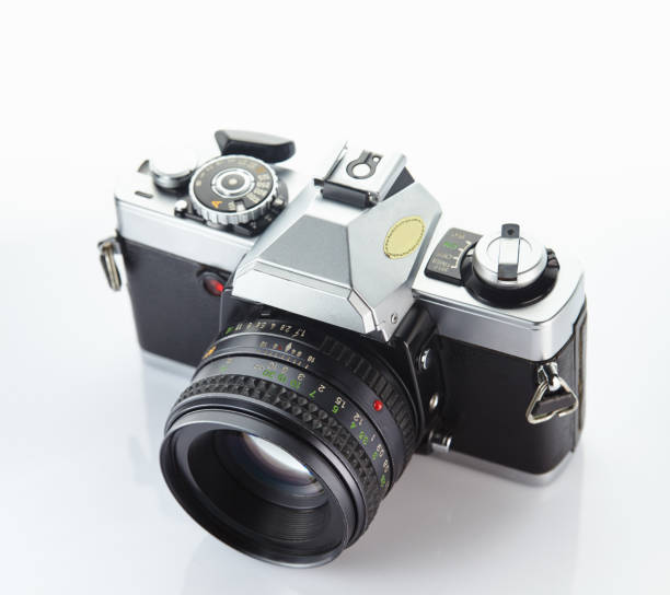 istock Old vintage film camera with lens isolated on white background 844402636