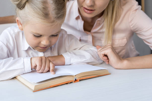 istock mother and daughter reading book 844403082