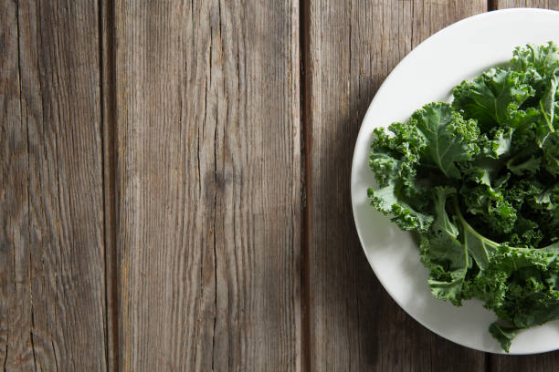 istock Kale vegetable in plate on wooden table 844405834