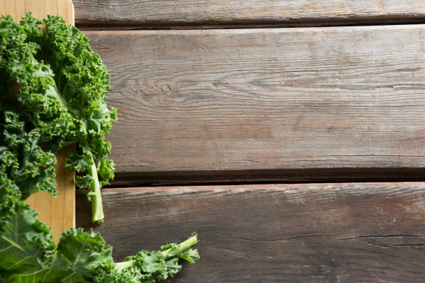 istock Fresh kale leaves on wooden board 844406078