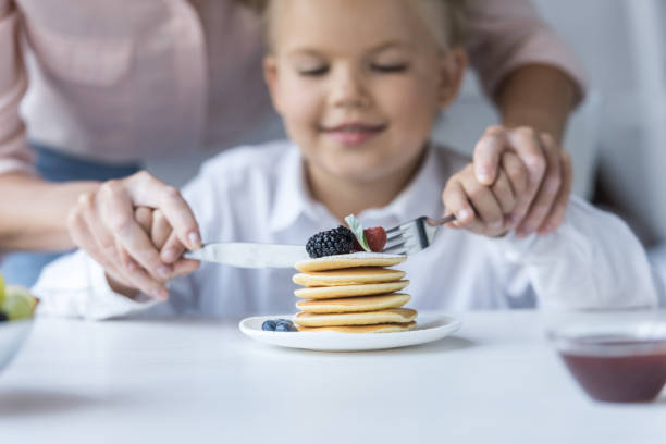 istock mother and daughter eating pancakes 844406264