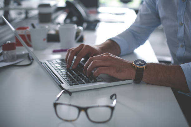 istock Business man working in office. Business man using laptop. Close up. 844409514
