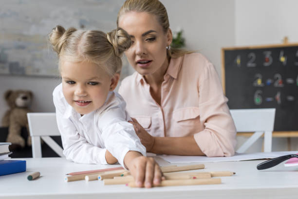istock mother and daughter with pencils 844409650