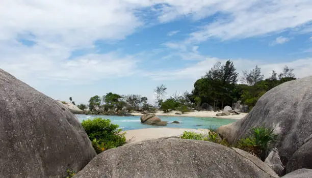 Natural rock formation on white sand beach in Belitung Island in the afternoon, Indonesia.