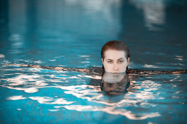 istock woman swimming inside the pool 844413768