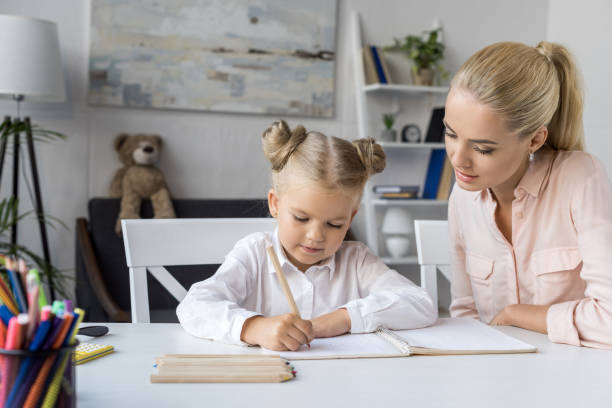 istock child drawing with mother 844413786