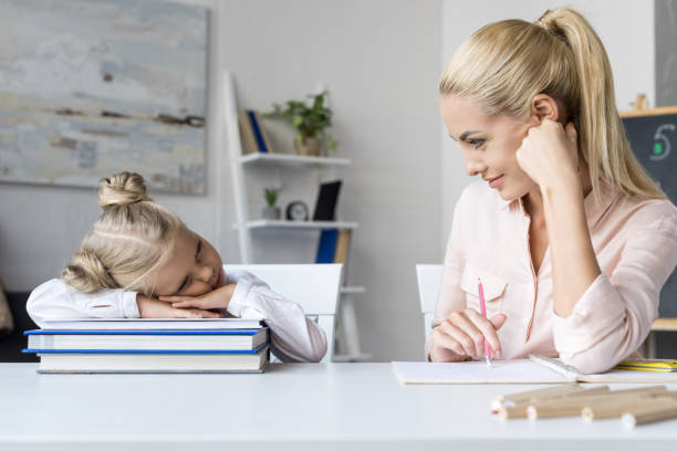istock mother and daughter studying at home 844413938