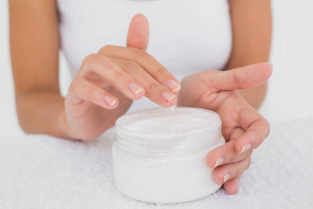 istock Mid section of woman applying cream 844416840