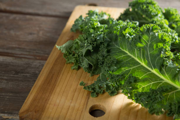 istock Kale leaves on wooden cutting board 844417300