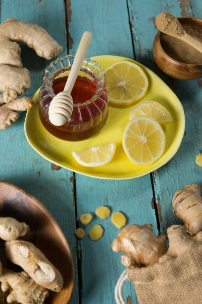 istock Lemon and gingers with honey jar on table 844420012