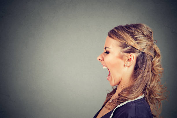 istock Side profile of an angry woman screaming 844420624